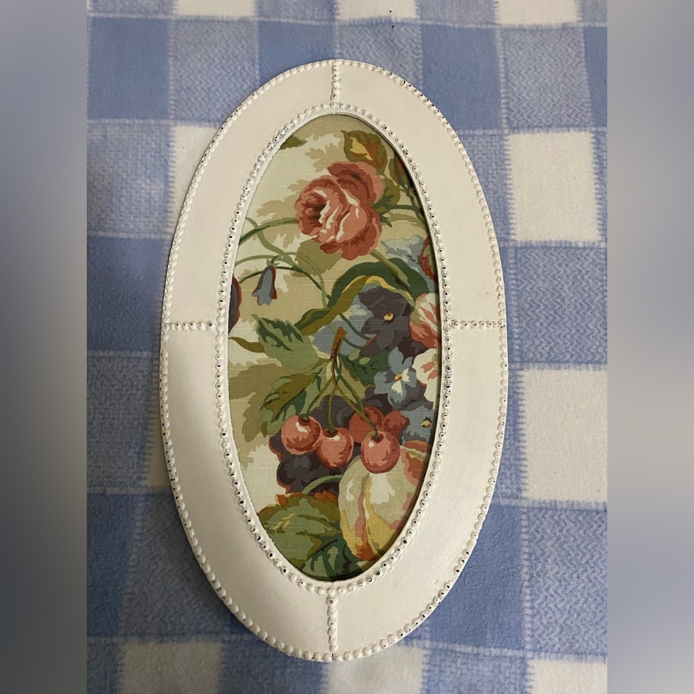 Farmhouse style antique frame with vintage fabric floral picture.